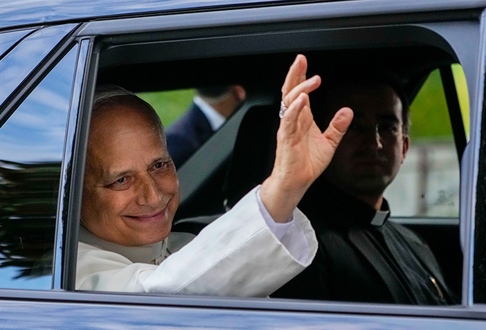 Pope Leo heads back to the Vatican as well-wishers cheer, in photos
